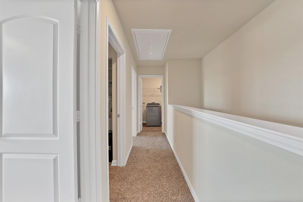 233 Lewis Lane Venus, TX 76084 - Photo 22 of 40 Upstairs hallway with carpeted flooring, attic access, and convenient flow between bedrooms, laundry, and living areas.