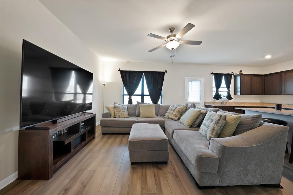 233 Lewis Lane Venus, TX 76084 - Photo 5 of 40 Spacious living area ideal for entertaining, offering neutral finishes, large windows, and open connection to the kitchen and dining space.