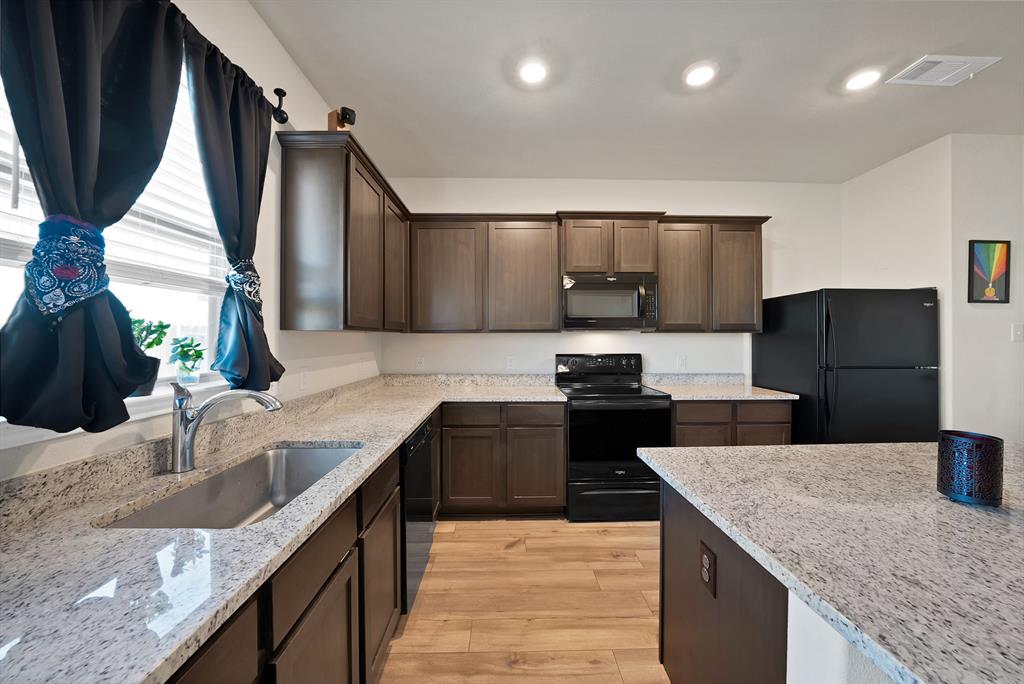 233 Lewis Lane Venus, TX 76084 - Photo 10 of 40 Kitchen countertops, large kitchen island and window over sink