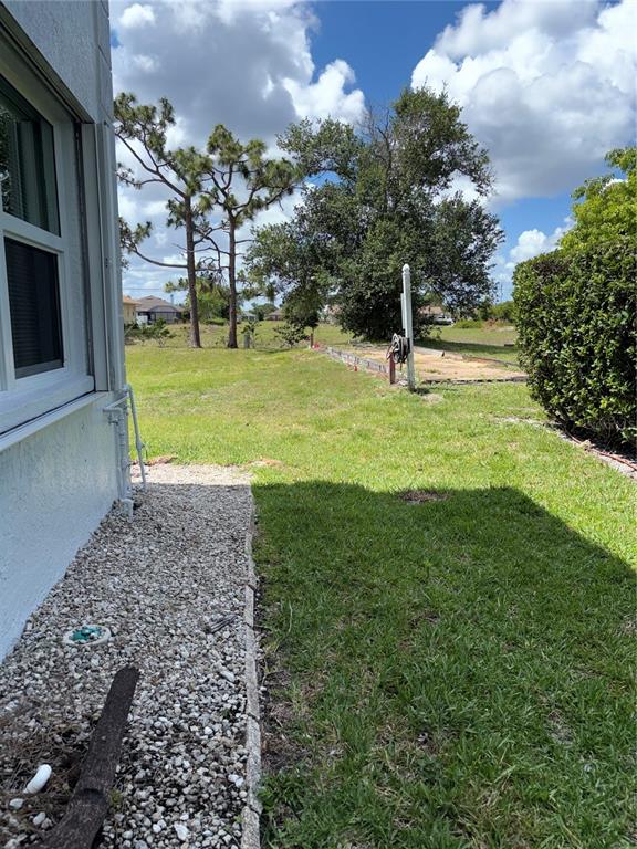 26485 Rampart Boulevard, Unit D1 Punta Gorda, FL 33983 - Photo 21 of 29 a front view of a house with a yard