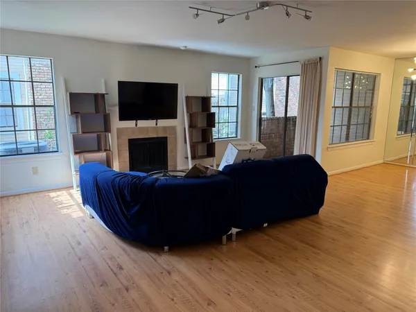 a living room with furniture flat screen tv and a fireplace