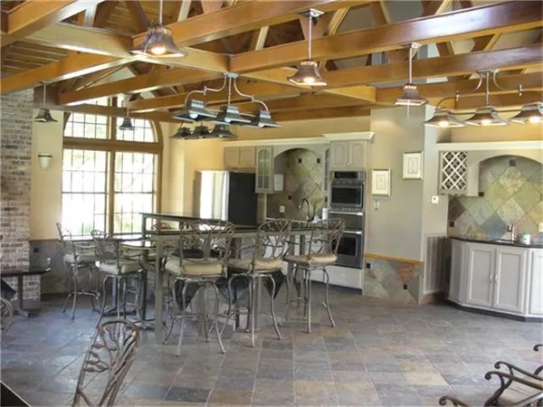 a view of backyard with swimming pool and furniture