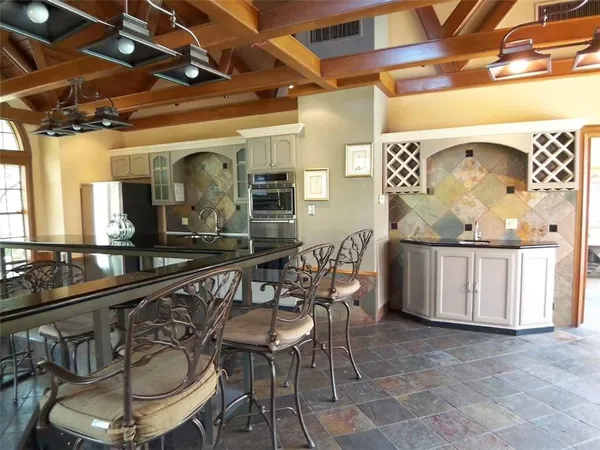 a view of swimming pool with lawn chairs and plants