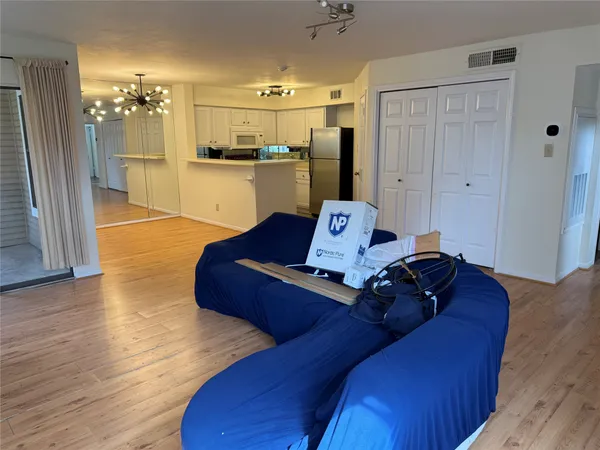 a living room with furniture and kitchen view