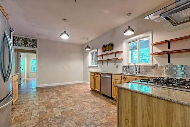 a view of an entryway with wooden floor and a window