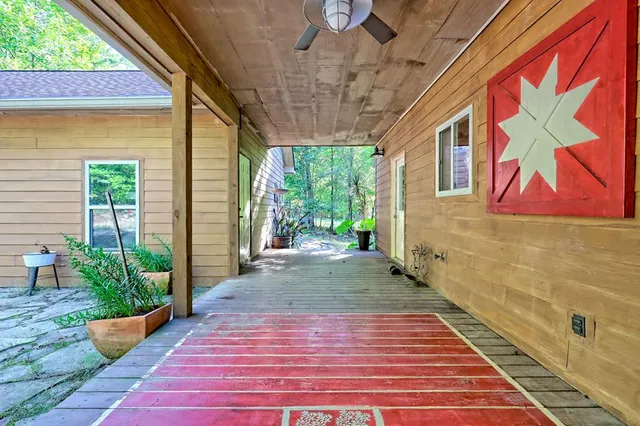 a backyard of a house with a garden and outdoor seating