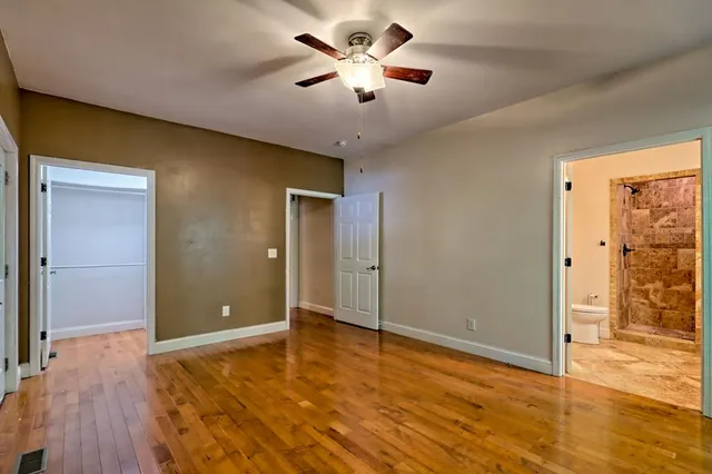 a view of a backyard with brick wall and plants