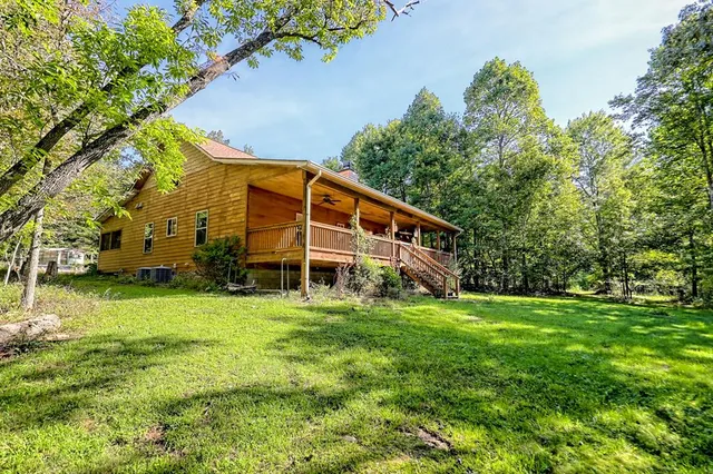 a kitchen with stainless steel appliances granite countertop a stove a sink dishwasher and a refrigerator with wooden floor