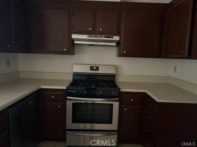 a kitchen with granite countertop a stove and a microwave