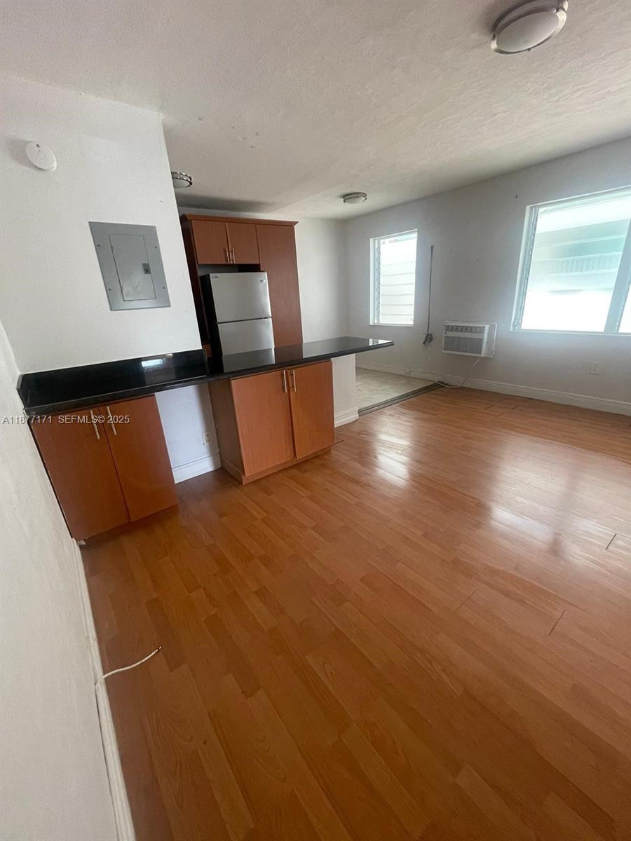 7928 Harding Avenue, Unit 1 Miami Beach, FL 33141 - Photo 11 of 17 a view of a room with window and wooden floor