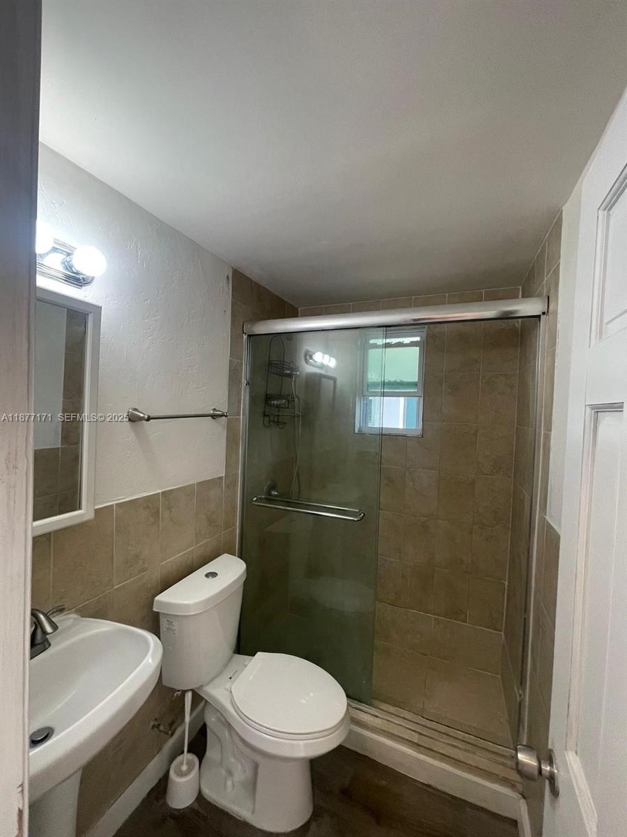 7928 Harding Avenue, Unit 1 Miami Beach, FL 33141 - Photo 15 of 17 a bathroom with a toilet and a sink