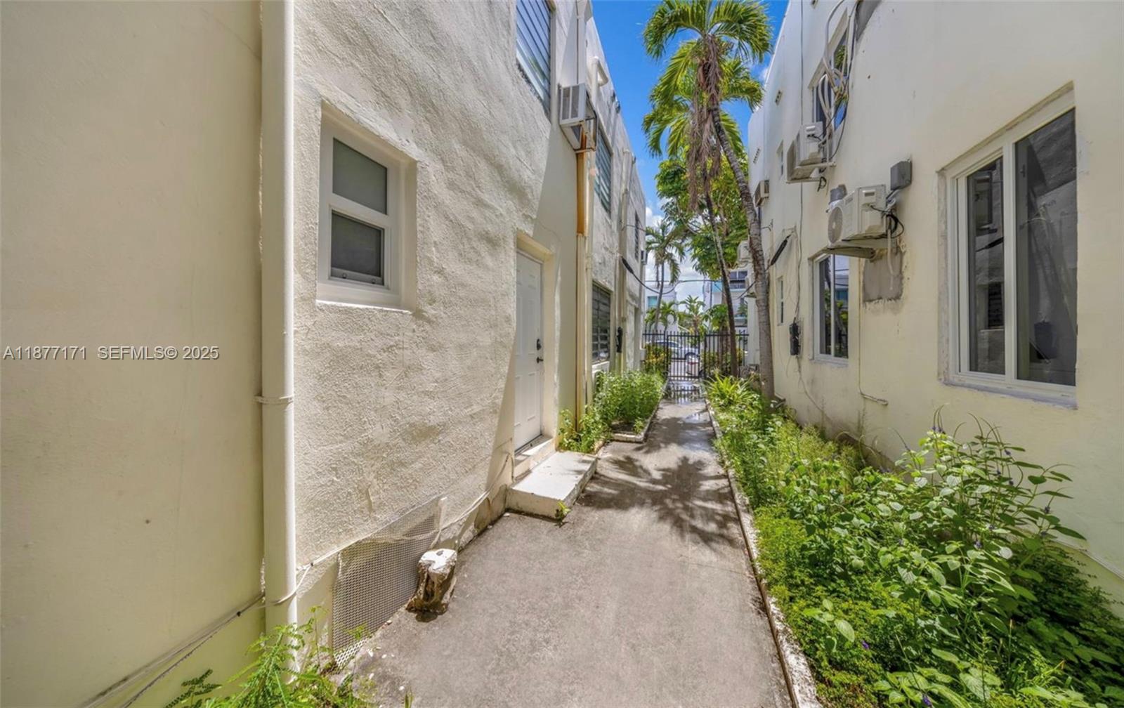 7928 Harding Avenue, Unit 1 Miami Beach, FL 33141 - Photo 4 of 17 a backyard of a house with outdoor seating