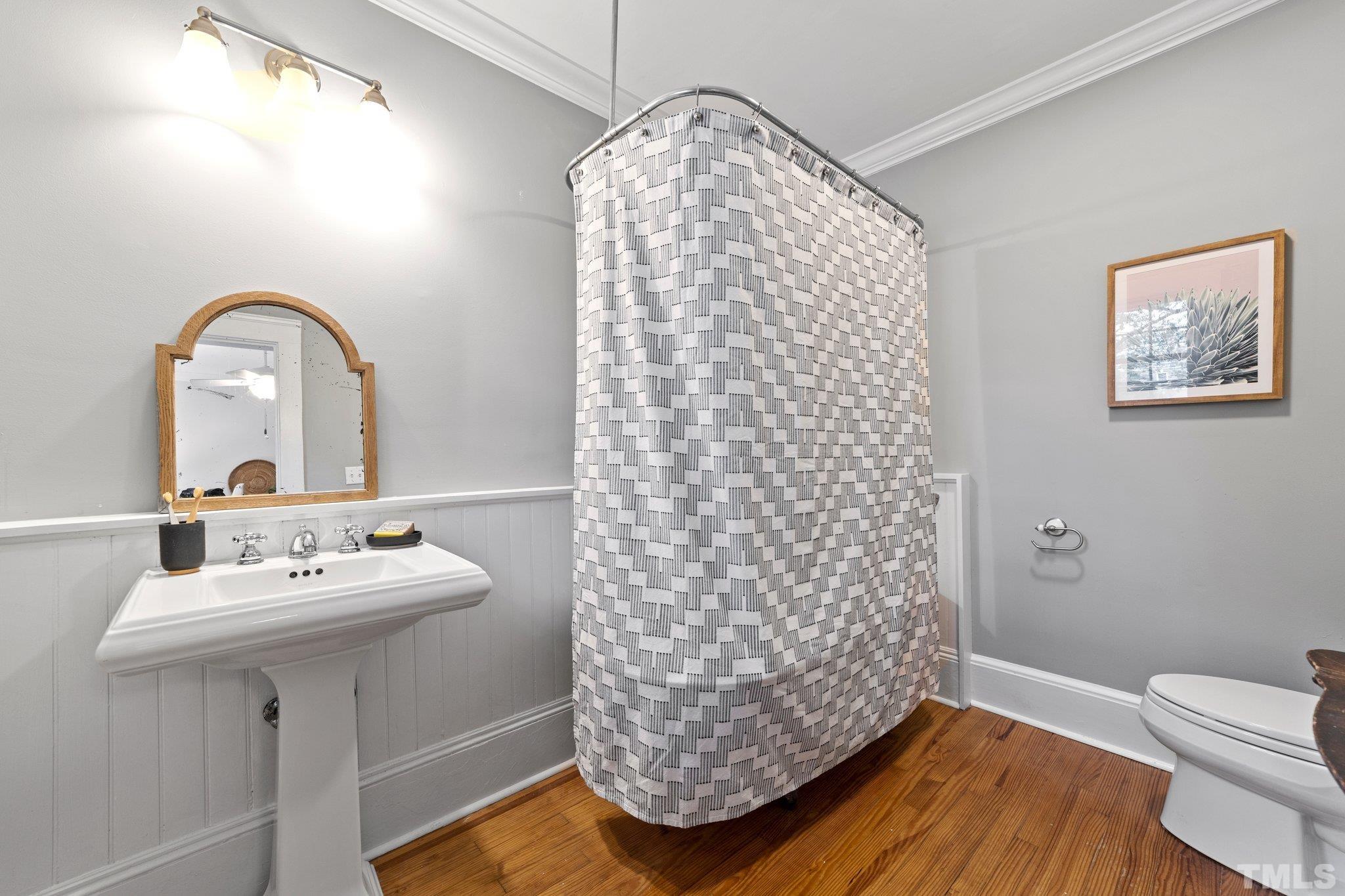 801 Onslow Street Durham, NC 27705 - Photo 19 of 30 a bathroom with a sink a mirror and a shower