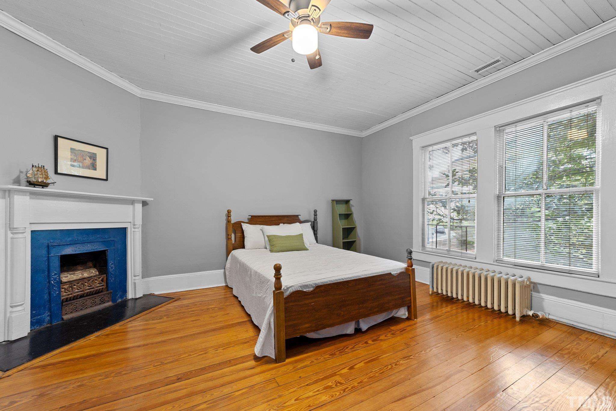 801 Onslow Street Durham, NC 27705 - Photo 21 of 30 a bedroom with a bed and a fireplace