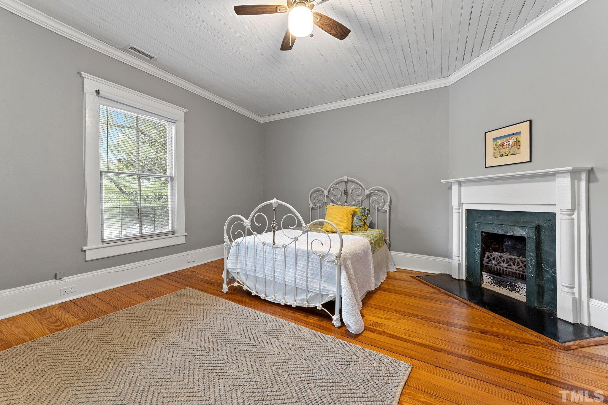 801 Onslow Street Durham, NC 27705 - Photo 23 of 30 a bedroom with a bed and a fireplace