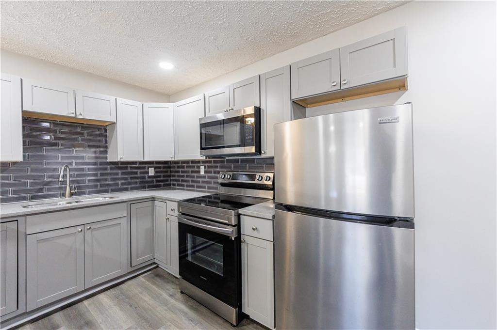 779 Amber Place Northwest Atlanta, GA 30331 - Photo 13 of 35 a kitchen with a refrigerator sink and microwave
