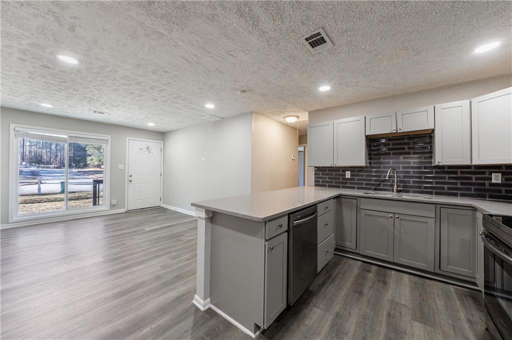 779 Amber Place Northwest Atlanta, GA 30331 - Photo 16 of 35 a kitchen with a sink cabinets and wooden floor