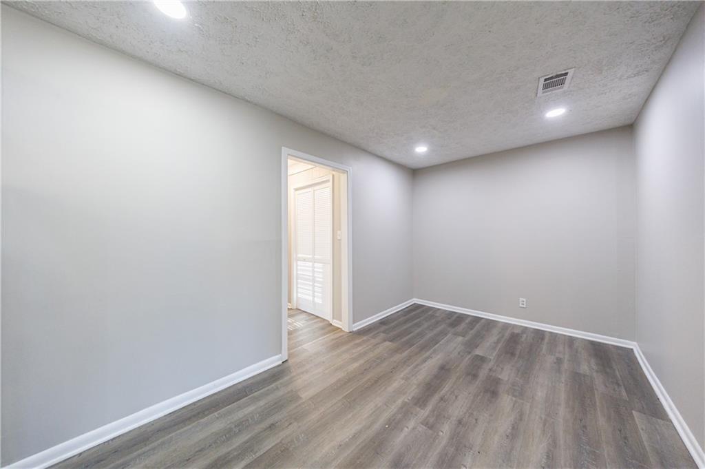 779 Amber Place Northwest Atlanta, GA 30331 - Photo 17 of 35 an empty room with wooden floor and windows