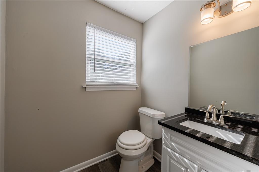 779 Amber Place Northwest Atlanta, GA 30331 - Photo 24 of 35 a bathroom with a granite countertop toilet and sink