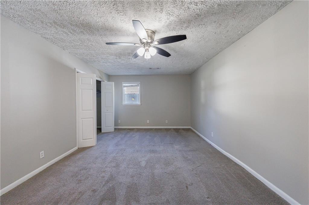 779 Amber Place Northwest Atlanta, GA 30331 - Photo 28 of 35 an empty room with windows and fan