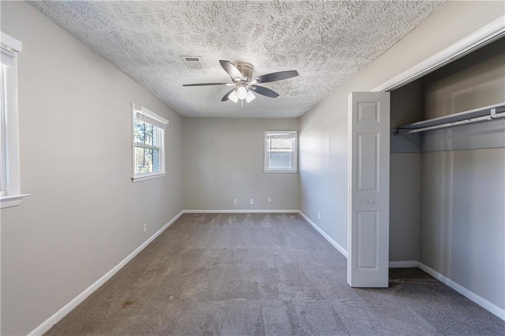779 Amber Place Northwest Atlanta, GA 30331 - Photo 31 of 35 an empty room with windows and fan