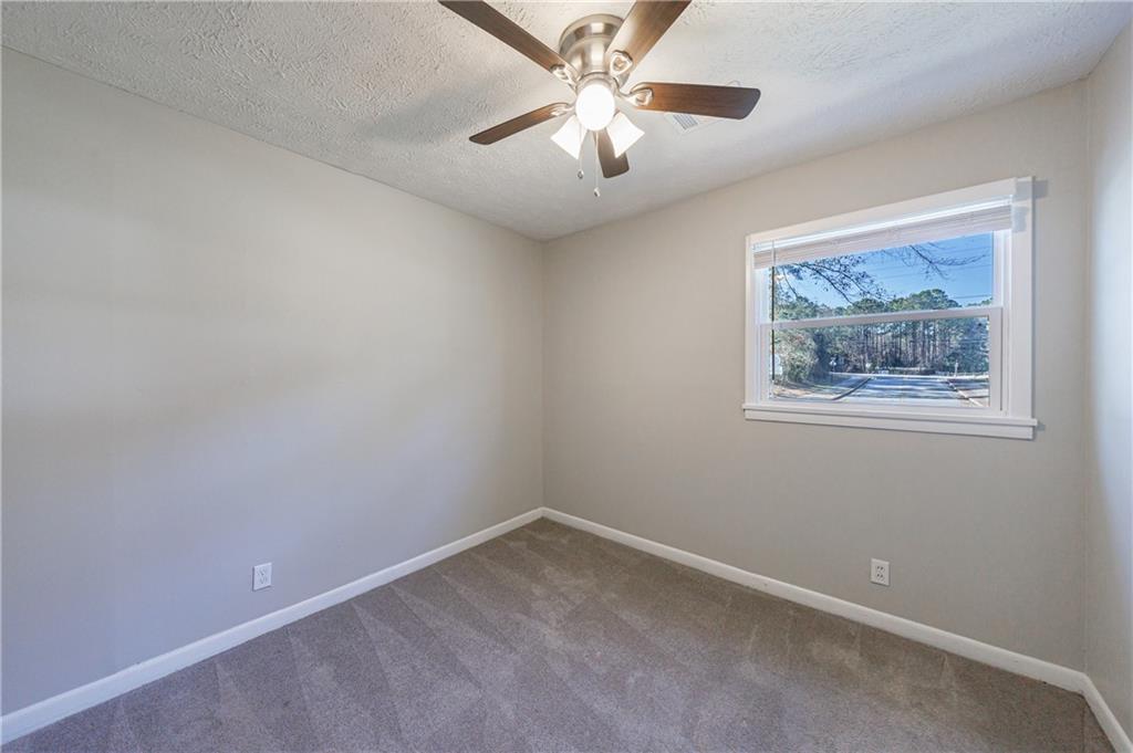 779 Amber Place Northwest Atlanta, GA 30331 - Photo 33 of 35 an empty room with a window and a fan