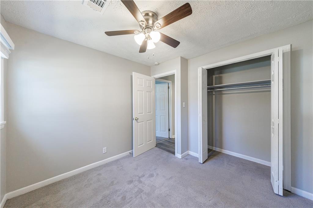 779 Amber Place Northwest Atlanta, GA 30331 - Photo 34 of 35 an empty room with closet and a ceiling fan