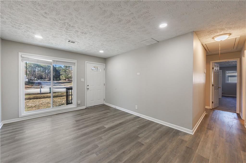 779 Amber Place Northwest Atlanta, GA 30331 - Photo 10 of 35 wooden floor in an empty room with a window