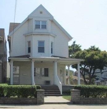 89-06 91st Avenue, Unit 2 Queens, NY 11421 - Photo 1 of 12 View of front of house featuring covered porch