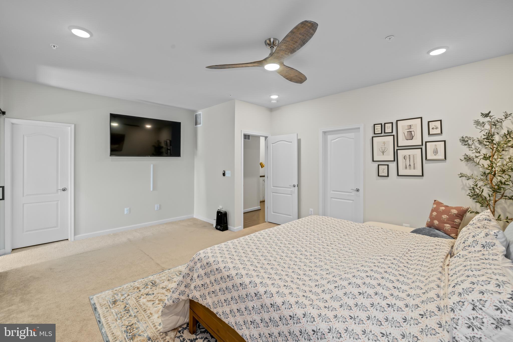 7715 Cresap Lane Hanover, MD 21076 - Photo 22 of 42 a bedroom with a large bed and a flat screen tv