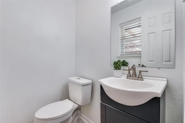 a bathroom with a sink a toilet and mirror