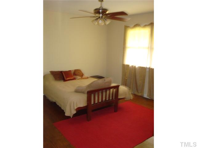 1600 Bennett Street Raleigh, NC 27604 - Photo 10 of 21 a bedroom with a bed and wooden floor