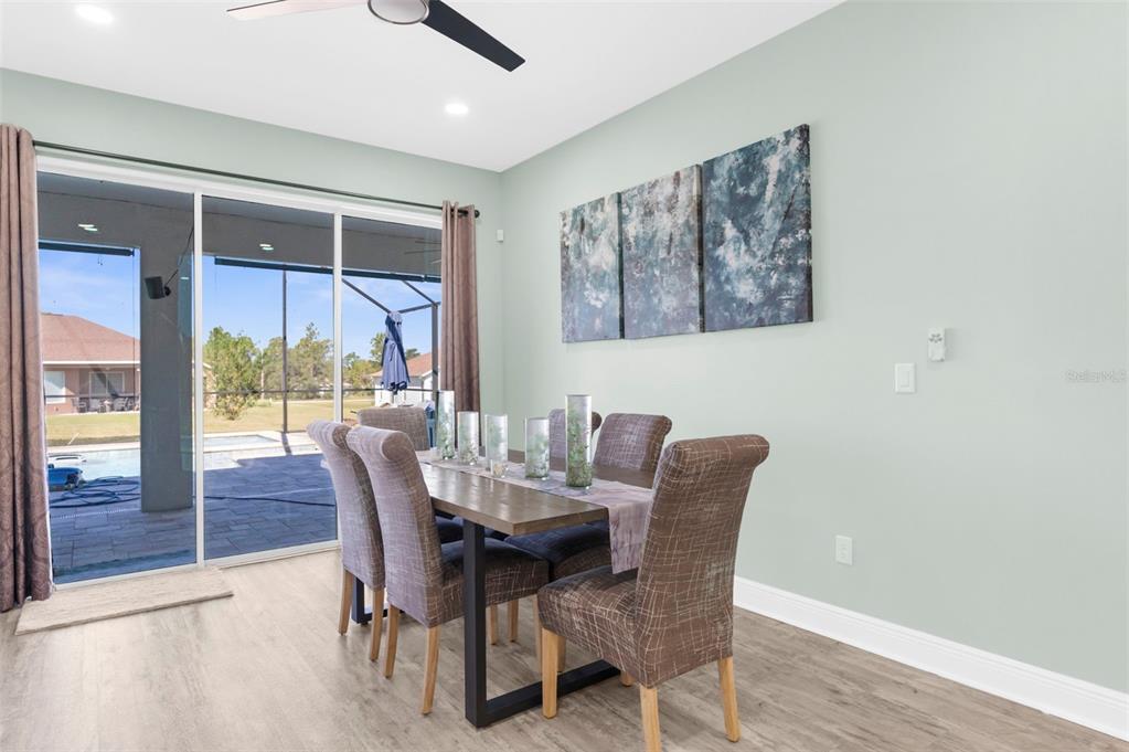 9347 North Star Court Weeki Wachee, FL 34613 - Photo 11 of 46 a dining room with furniture a rug and a large window