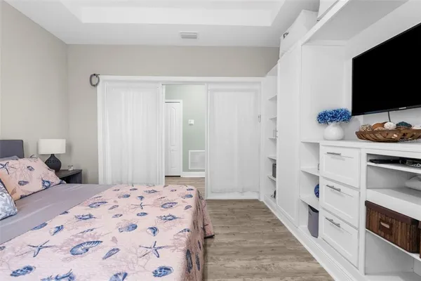 a large kitchen with stainless steel appliances kitchen island a large counter top a stove a chimney a sink and a refrigerator