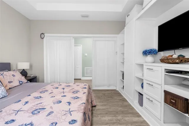 a large kitchen with stainless steel appliances kitchen island a large counter top a stove a chimney a sink and a refrigerator