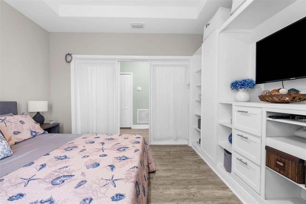 9347 North Star Court Weeki Wachee, FL 34613 - Photo 17 of 46 a bedroom with a bed and a flat screen tv