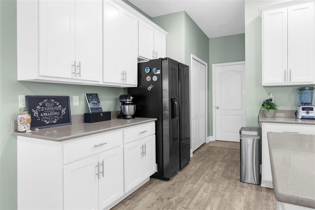 9347 North Star Court Weeki Wachee, FL 34613 - Photo 20 of 46 a kitchen with stainless steel appliances granite countertop a refrigerator sink and cabinets