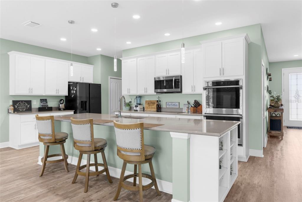 9347 North Star Court Weeki Wachee, FL 34613 - Photo 2 of 46 a kitchen with stainless steel appliances a stove a sink a microwave a refrigerator and cabinets