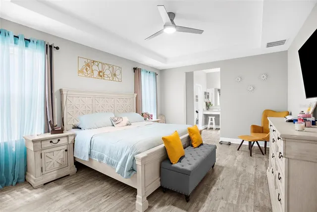 a bathroom with a granite countertop sink a mirror a vanity and shower