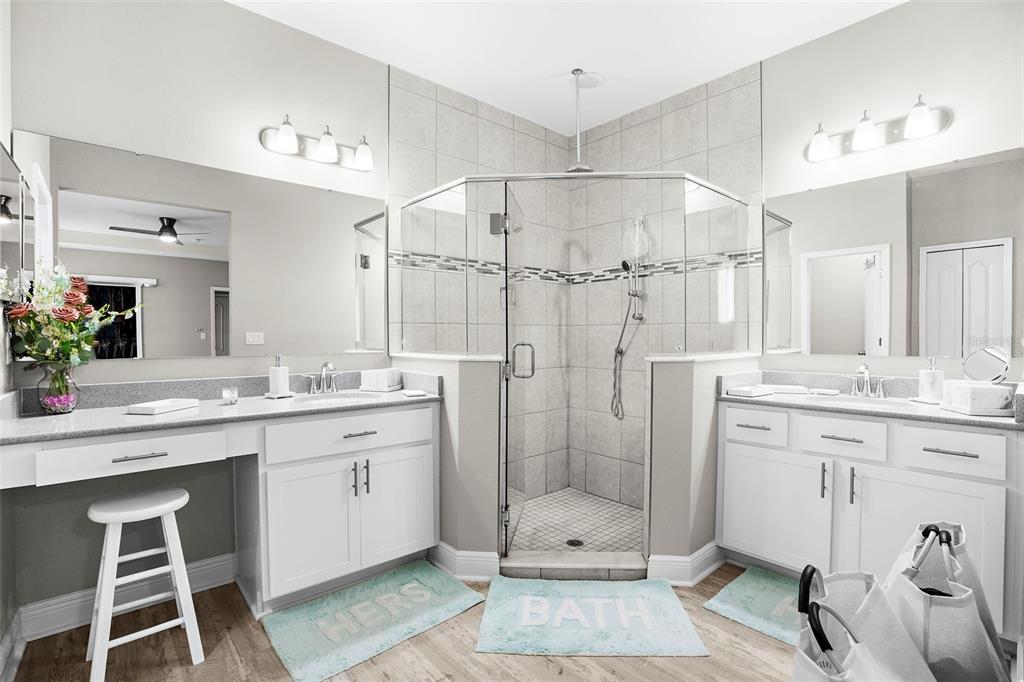 9347 North Star Court Weeki Wachee, FL 34613 - Photo 23 of 46 a bathroom with a granite countertop sink a mirror a vanity and shower