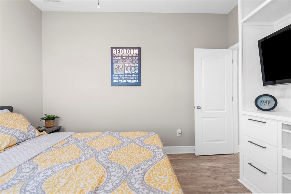 9347 North Star Court Weeki Wachee, FL 34613 - Photo 29 of 46 a bedroom with a bed and a flat screen tv