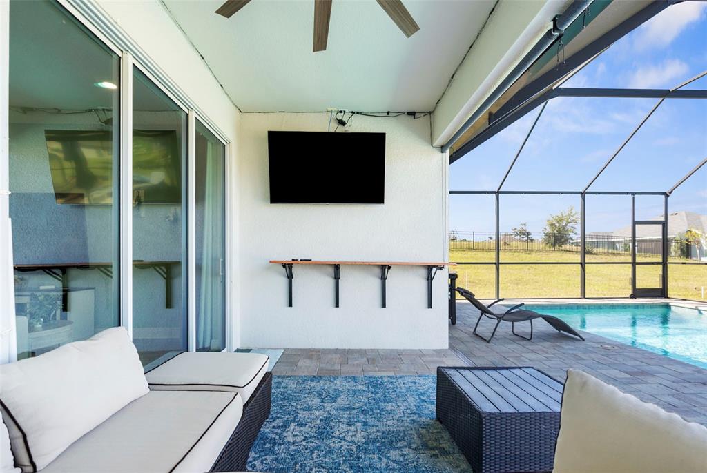 9347 North Star Court Weeki Wachee, FL 34613 - Photo 31 of 46 a living room with a couch and a flat screen tv