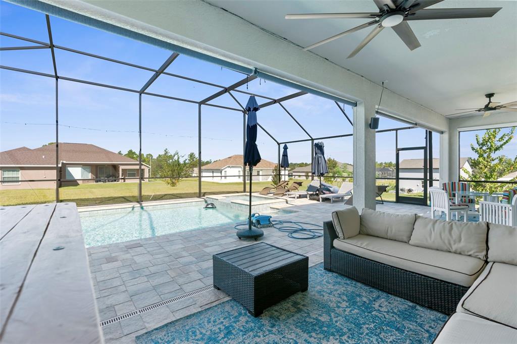 9347 North Star Court Weeki Wachee, FL 34613 - Photo 36 of 46 a living room with couch and a floor to ceiling window