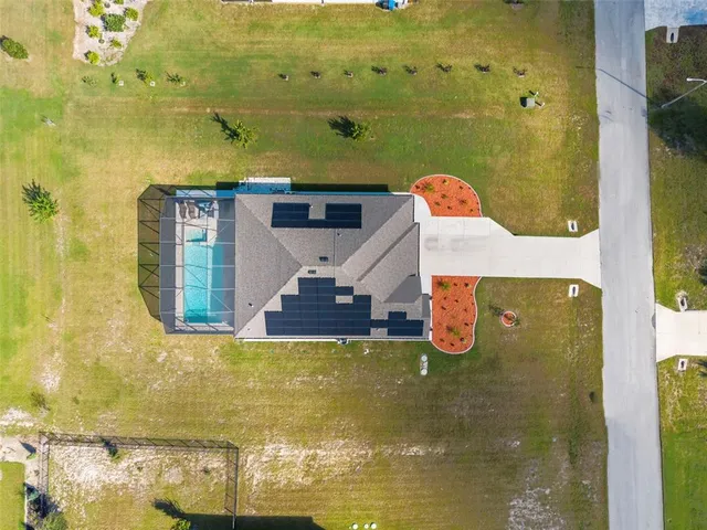 a front view of a house with a garden and yard