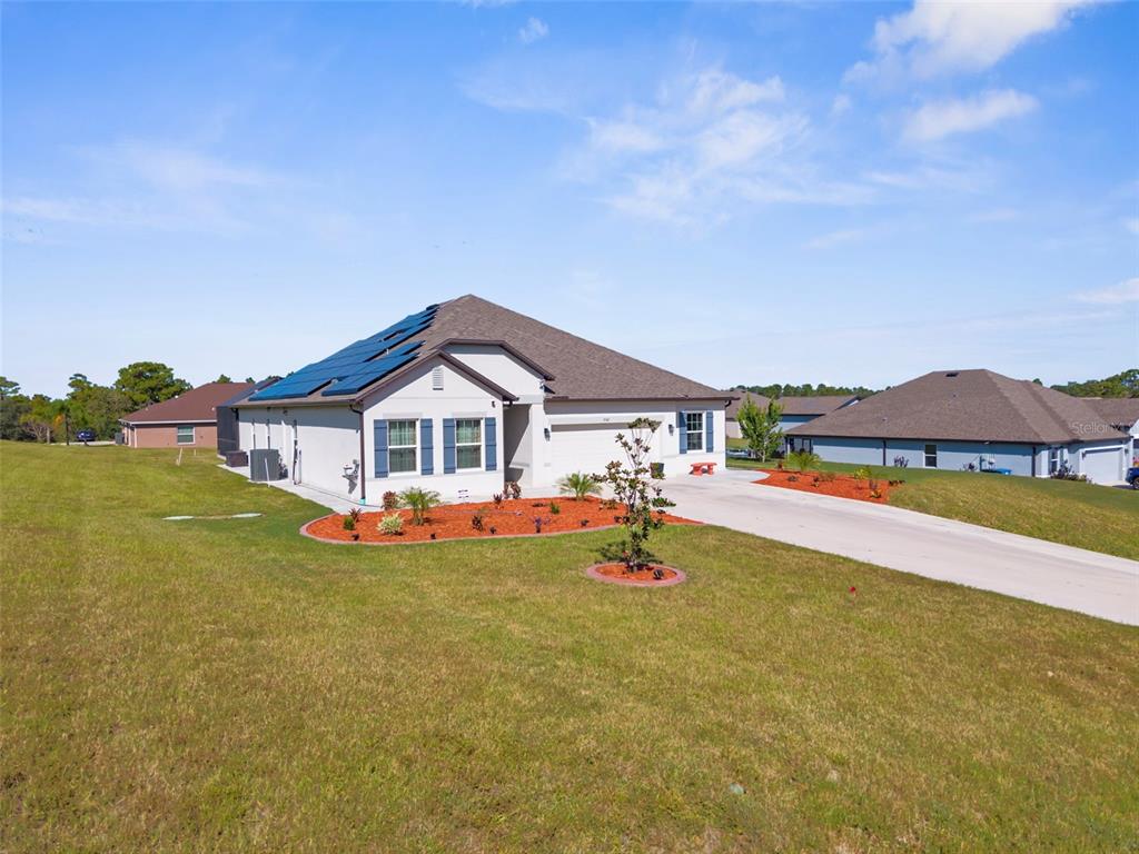 9347 North Star Court Weeki Wachee, FL 34613 - Photo 45 of 46 a front view of a house with a big yard and large trees