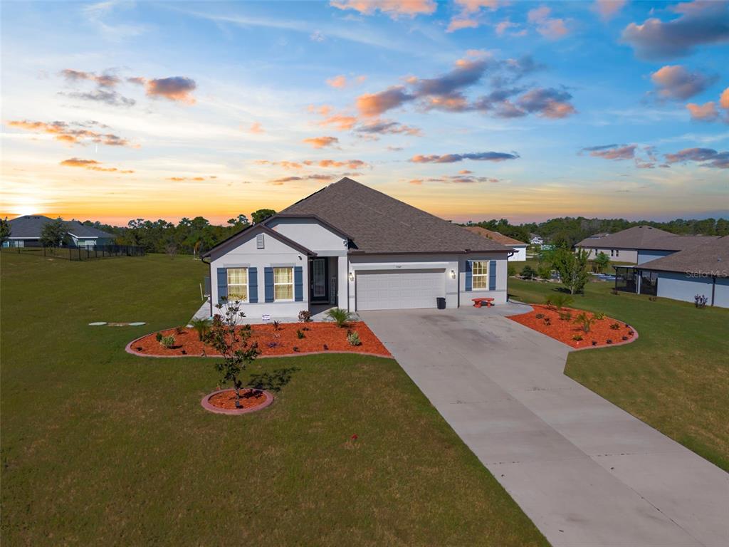 9347 North Star Court Weeki Wachee, FL 34613 - Photo 46 of 46 a front view of a house with a garden and yard