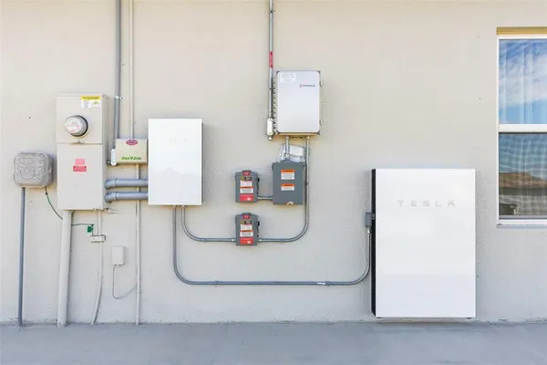 a living room with furniture kitchen view and a potted plant
