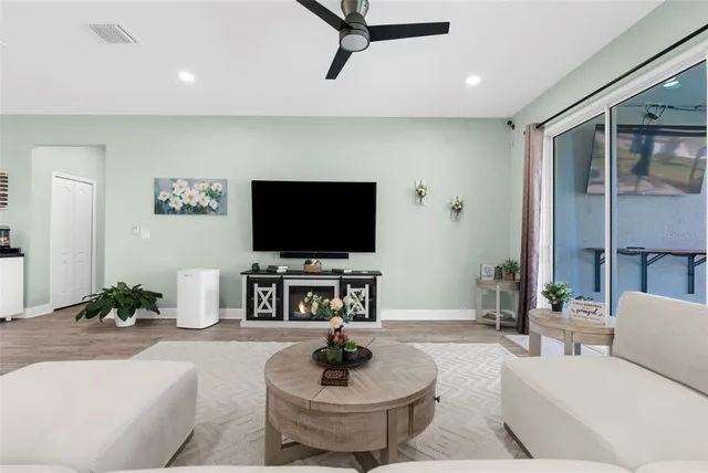 a dining room with furniture a rug and a large window
