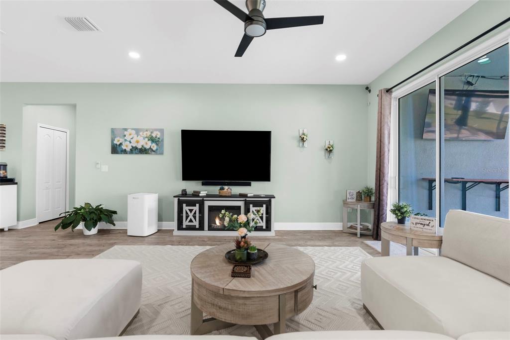 9347 North Star Court Weeki Wachee, FL 34613 - Photo 10 of 46 a living room with furniture and a flat screen tv