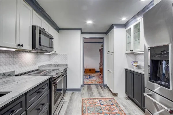 a kitchen with stainless steel appliances granite countertop a stove and a refrigerator